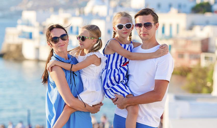 Family of four in a coastal town, representing relocation, lifestyle benefits, and residency by investment programs.