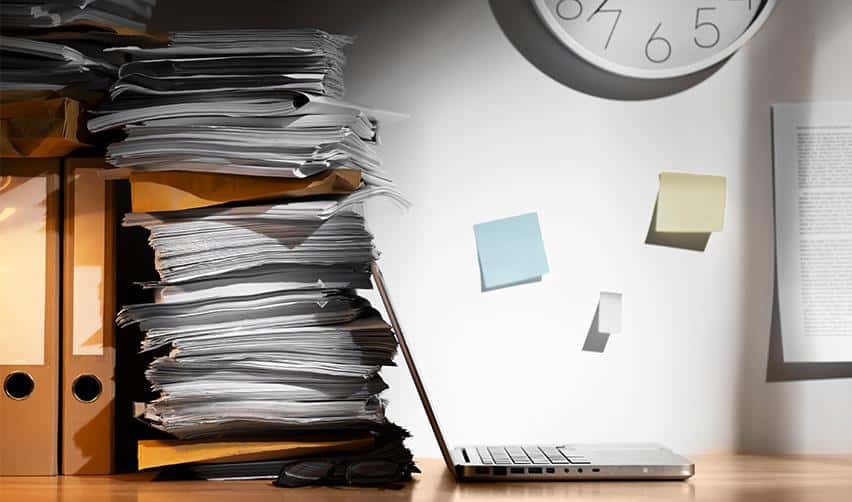 Stack of immigration documents and filing paperwork representing EB5 visa application processing times.