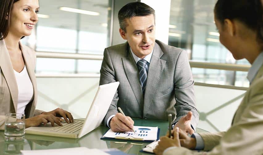 EB5 immigration attorney or regional center representative consulting with foreign investors on visa requirements and regional center investment options.